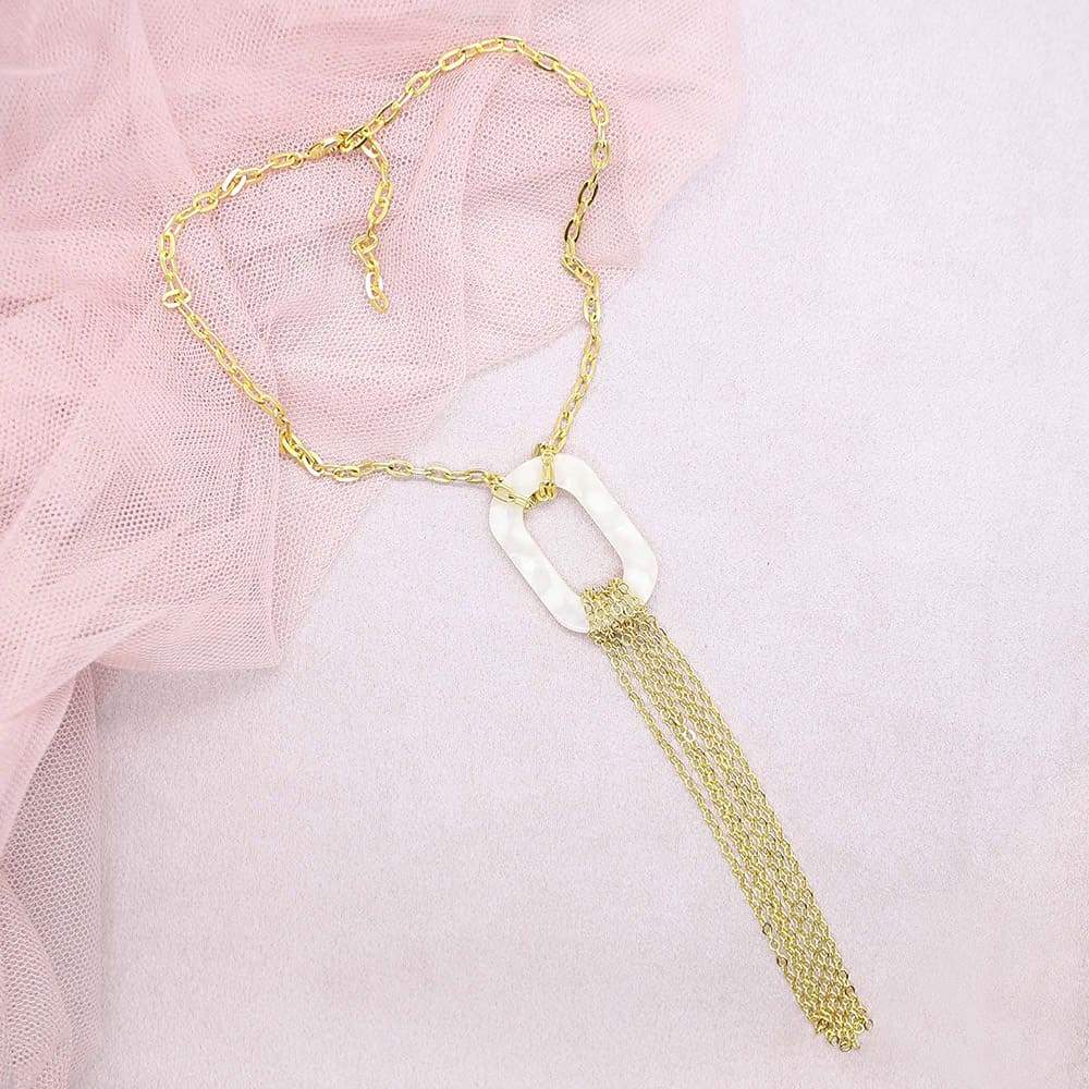 Ivory Joss Gold Tassel Necklace on pink