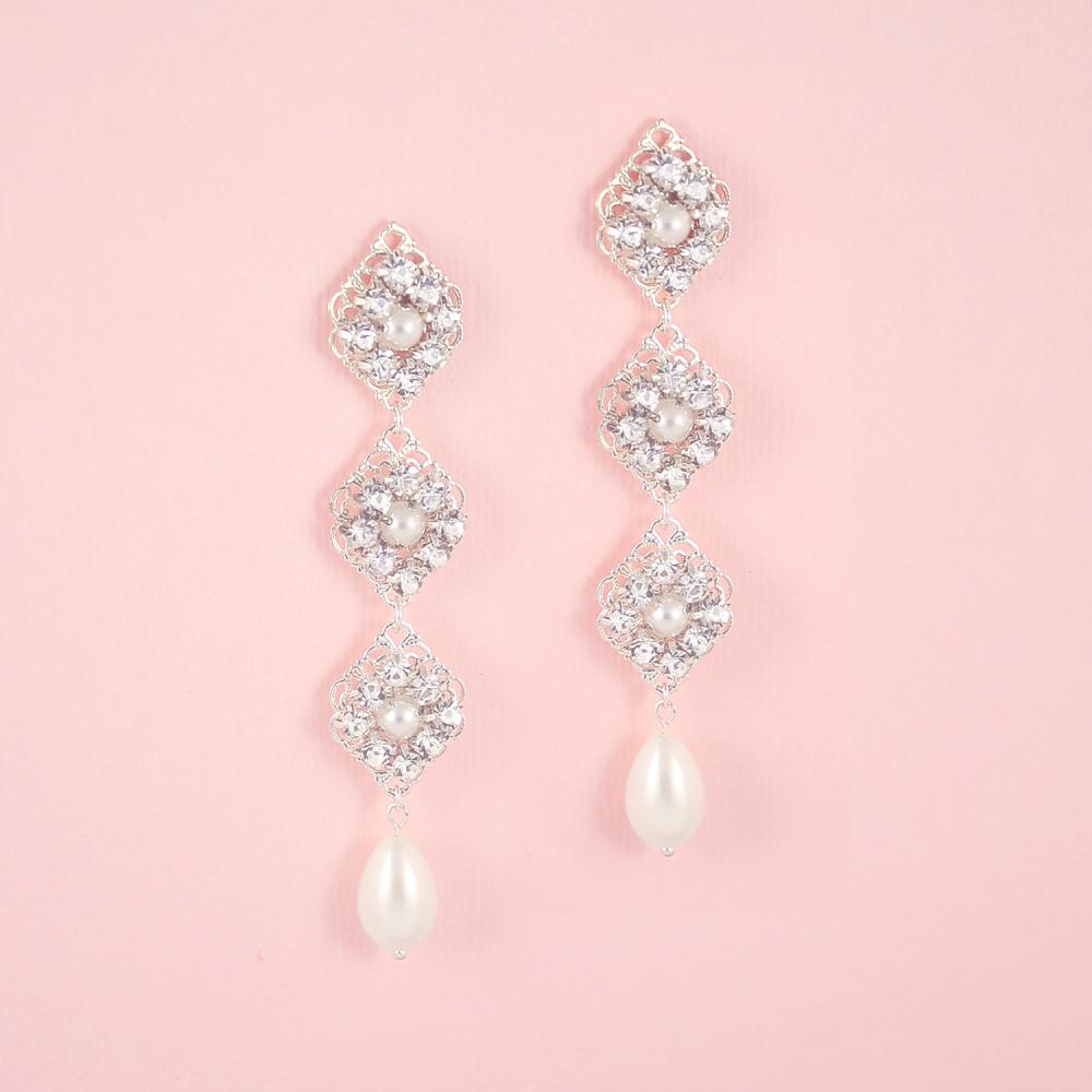 Silver Kaya Bridal Pearl Drop Earrings on pink