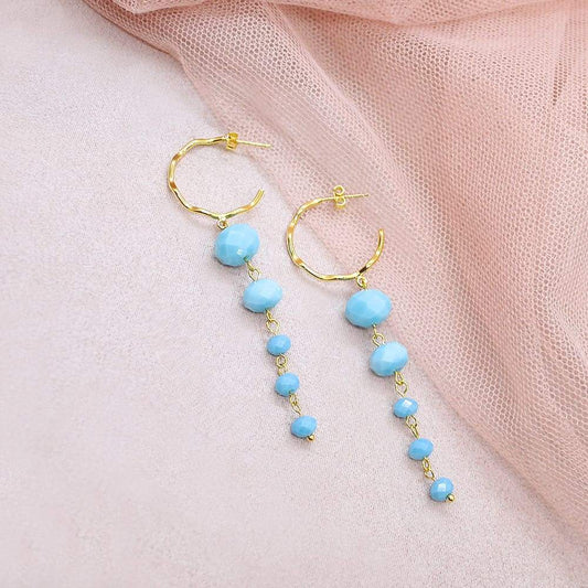 Turquoise Kelana Dangle Bead Earrings on pink