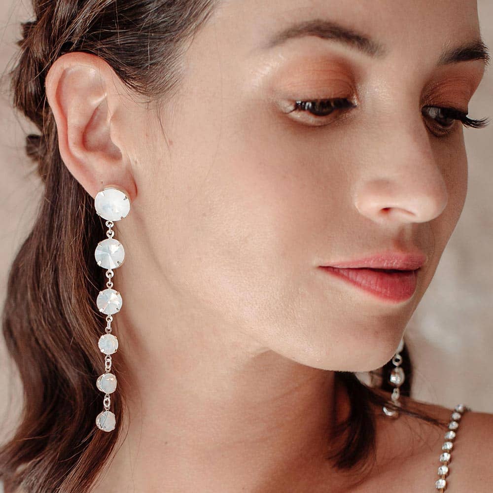 Kelsey Crystal Drop Earrings in White on right ear