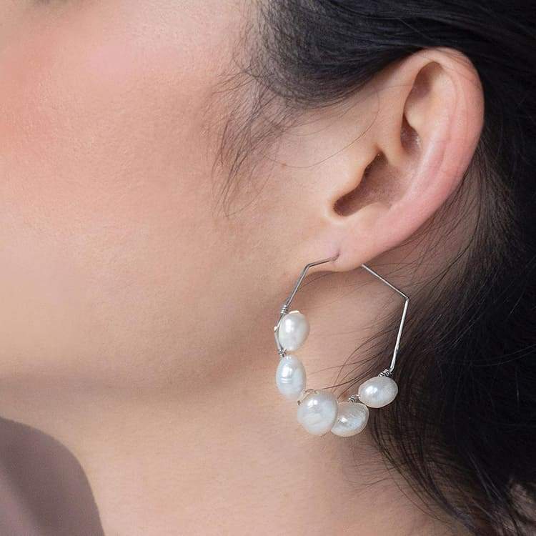 Kygo freshwater pearl geo earrings on left ear