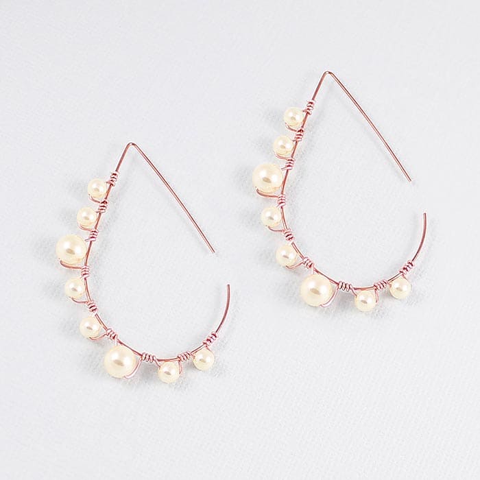 Lulu pearl teardrop hoop earrings rose gold with cream pearls on grey background