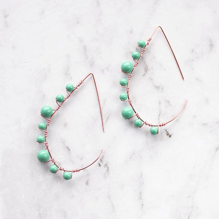 Lulu pearl threader hoop earrings rose gold with turquoise on marble background