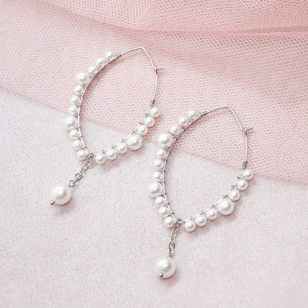 Off-white Ora Pearl Hoop Earrings on pink