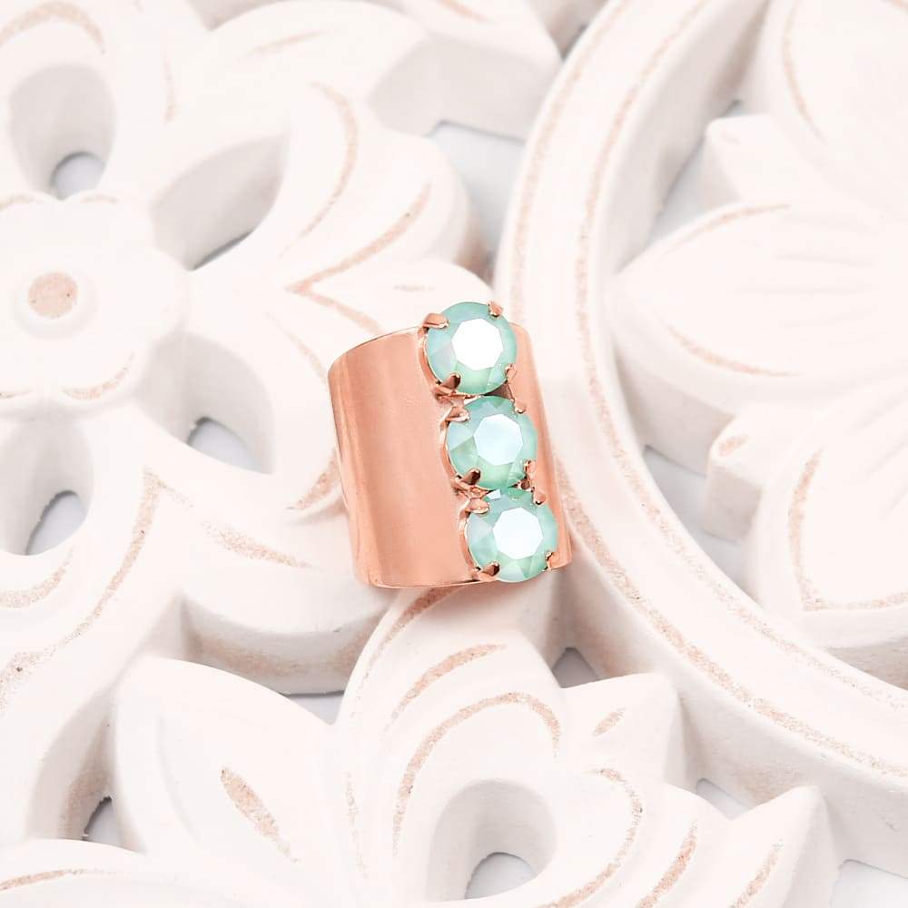 Rose Gold with Mint Simone Crystal Statement Ring on white floral plate.