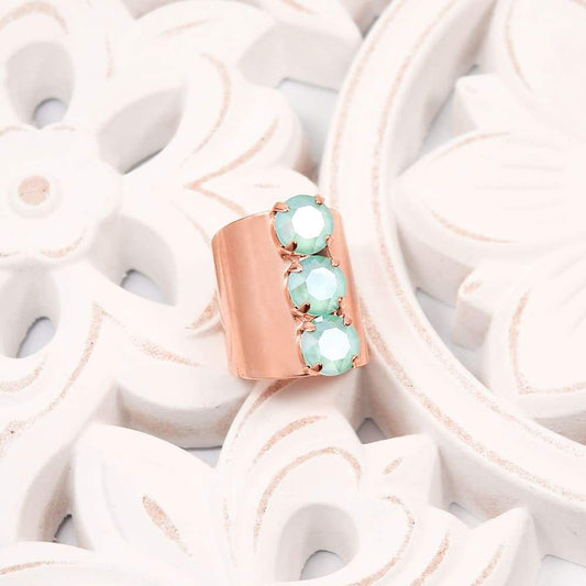 Rose Gold with Mint Simone Crystal Statement Ring on white floral plate.