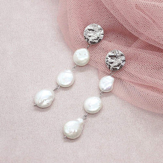 White Sloan Freshwater Pearl Earrings on pink