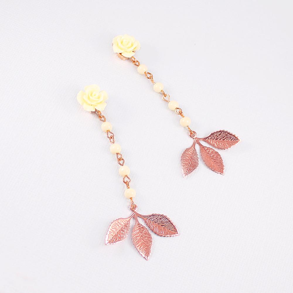Rose gold Thea Leaf Earrings on grey