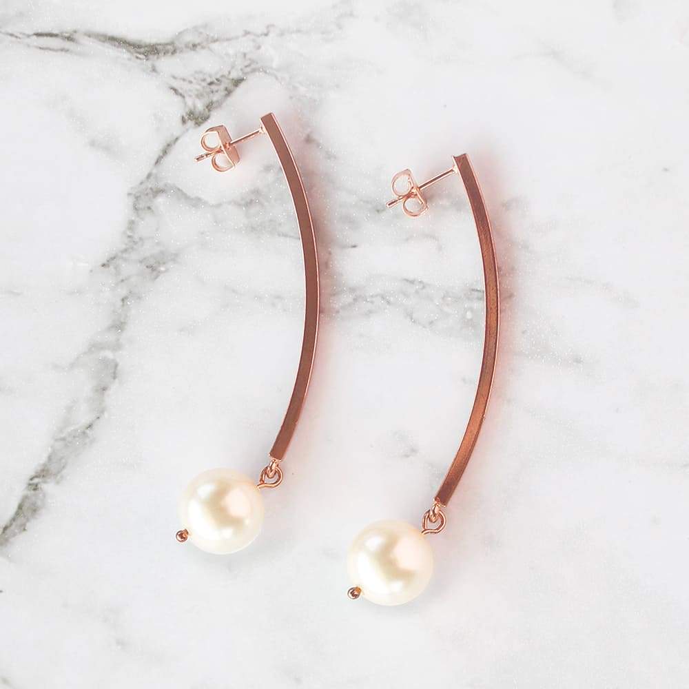 Rose Gold with Ivory Virgo Long Bar Pearl Earrings on grey